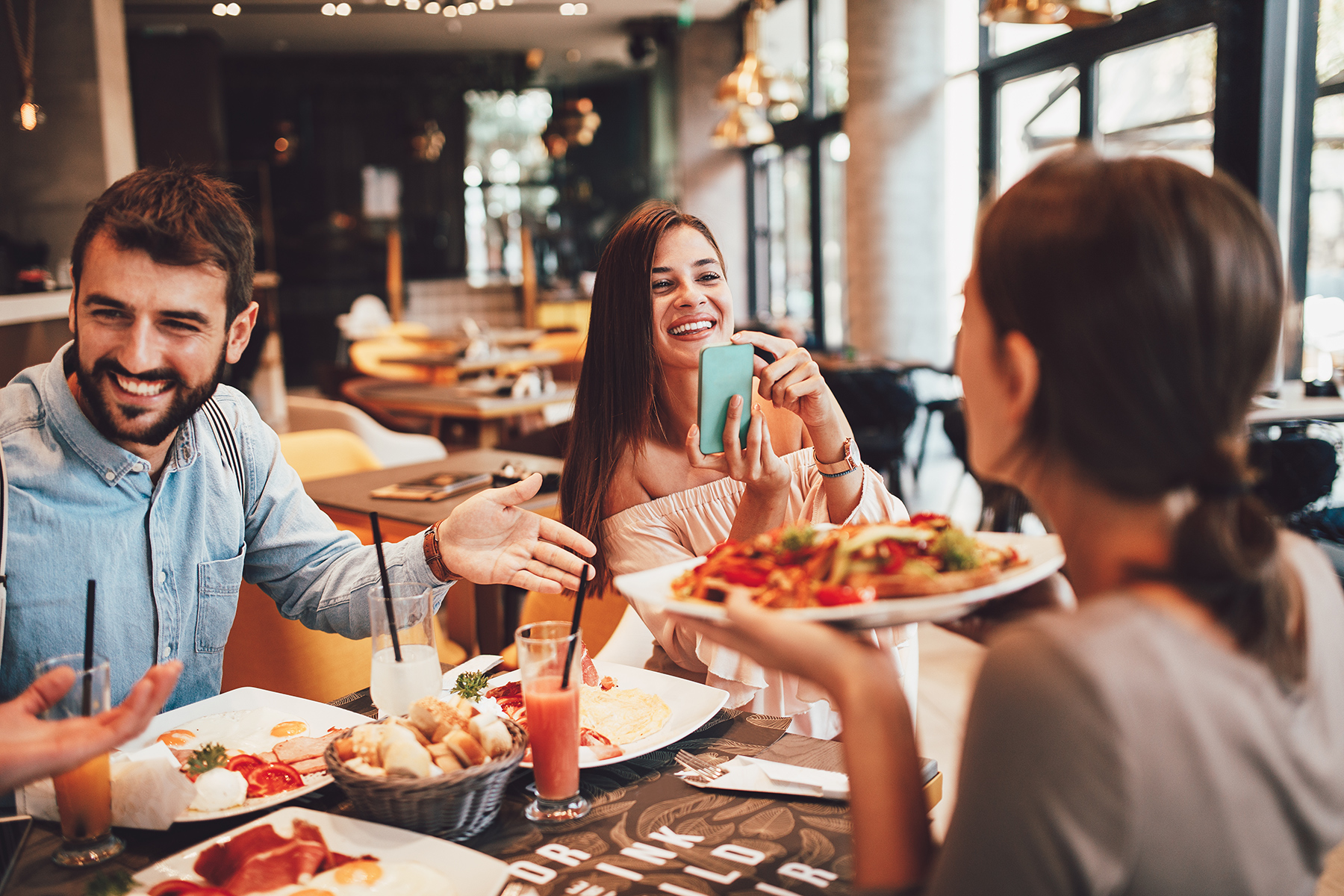 Friends enjoying a meal at a lively restaurant in Austin