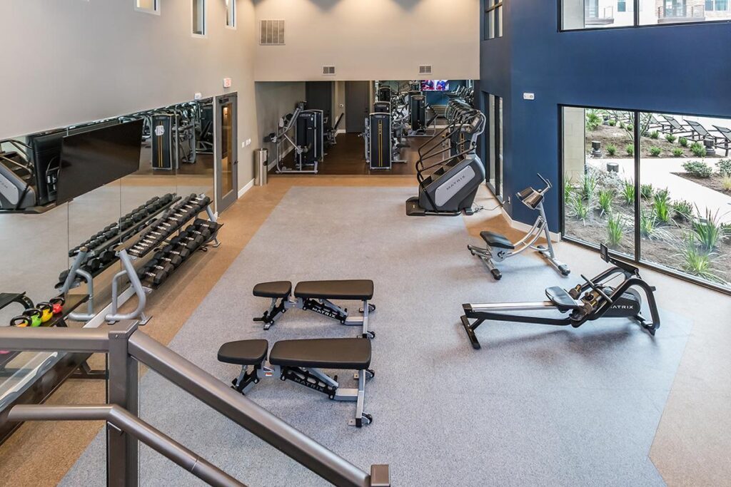 Indoor gym area with workout machines and cardio machines