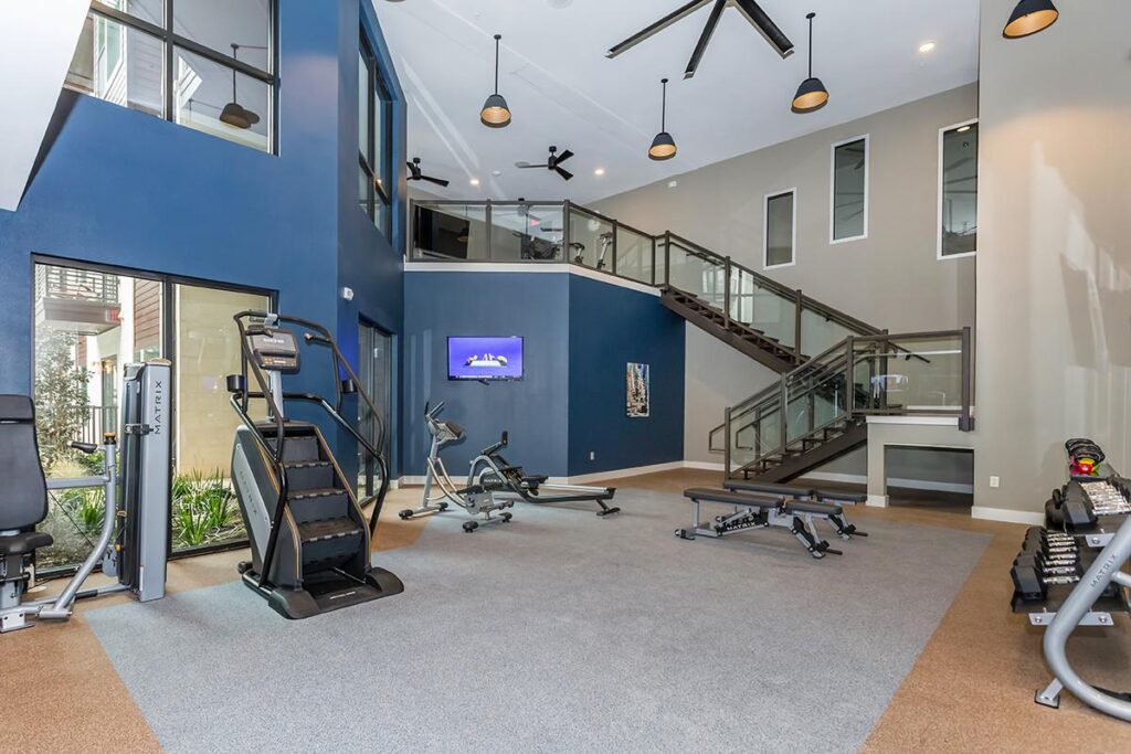 Indoor gym area with workout machines and cardio machines