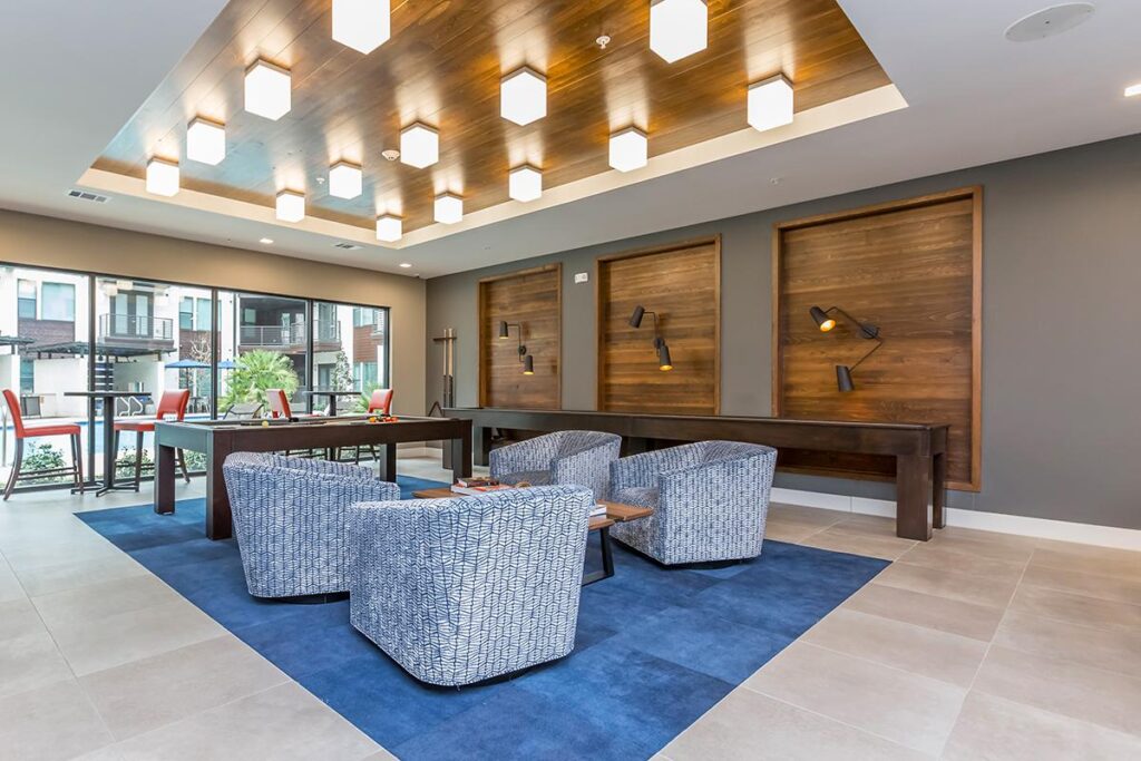 Clubhouse interior with chair seating, pool table and shuffleboard